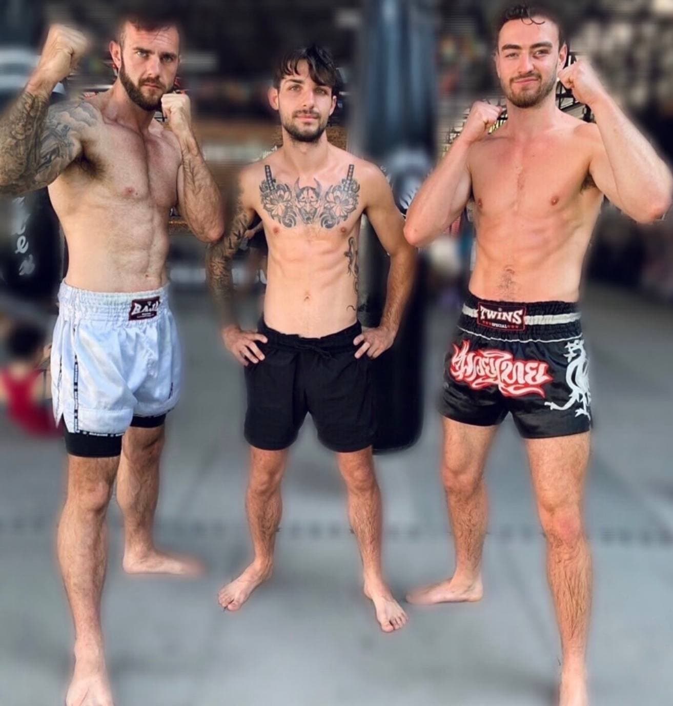 Fighters and coaches ringside in a Thailand gym